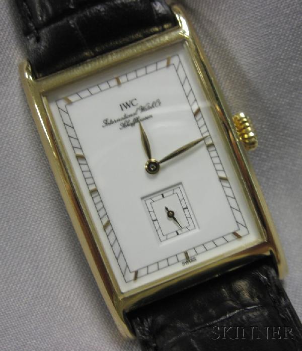 18kt Gold Wristwatch, IWC Schaffhausen, the white : 18kt Gold Wristwatch, IWC Schaffhausen, the white metal dial with abstract numeral indicators and subsidiary seconds dial, enclosing manual-wind movement, rectangular bezel, case no. 2499564, 31 x 23 