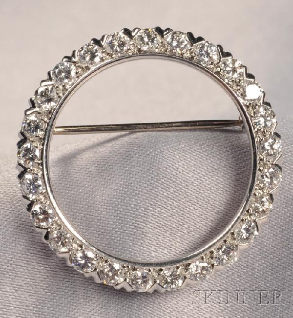 Platinum and Diamond Circle Brooch, McTeigue, set: Platinum and Diamond Circle Brooch, McTeigue, set with twenty-fine full-cut diamonds, approx. total wt. 1.75 cts., dia. 1 1/8 in., maker's mark.