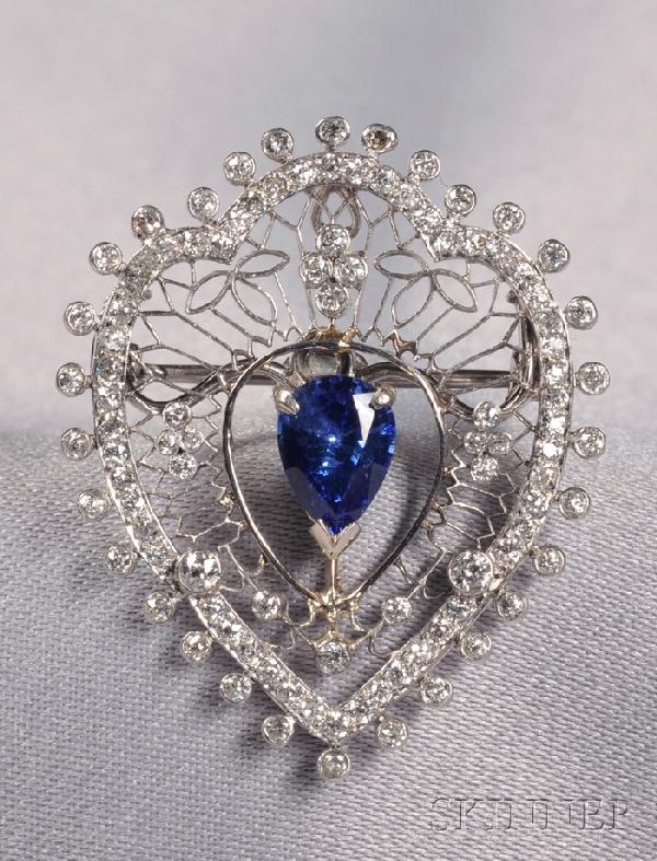 Edwardian Platinum and Diamond Pendant/Brooch, Mar: Edwardian Platinum and Diamond Pendant/Brooch, Marcus & Co., the finely pierced mount set with old mine-cut diamond melee, centering a later pear-shape sapphire, lg. 1 1/4 in., signed.