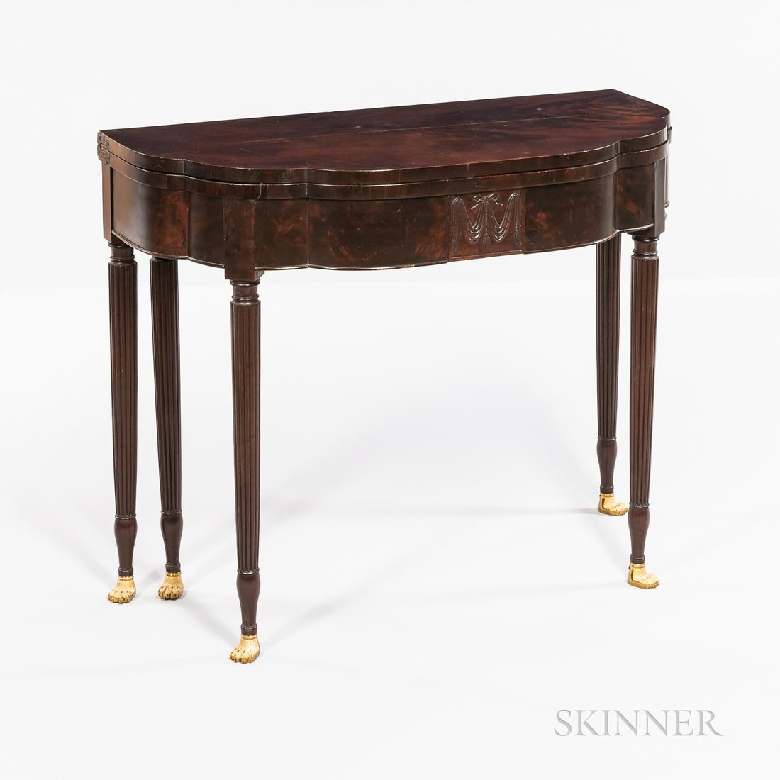 Federal Carved Mahogany Card Table, attributed to: Federal Carved Mahogany Card Table, attributed to Duncan Phyfe, New York, c. 1810, with triple-elliptic top above a conformingly shaped frame centering a panel with bowknotted swag, joining five ring-