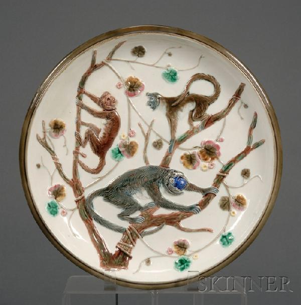 Wedgwood Argenta Majolica Compote with Monkeys, En: Wedgwood Argenta Majolica Compote with Monkeys, England, c. 1879, polychrome decorated with monkeys perched on branches with scattered foliage, mounted atop a tree trunk base, impressed mark, dia. 11 