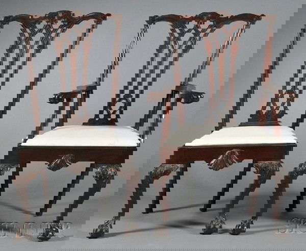 Set of Twelve Chippendale-style Carved Mahogany D: Set of Twelve Chippendale-style Carved Mahogany Dining Chairs, comprising two armchairs and ten side chairs, each with carved vasiform splat, slip seat, shell-carved apron, and acanthus-carved cabriol