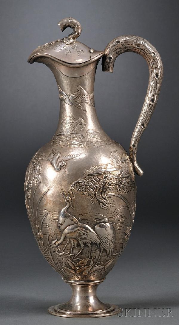 Chinese Export Silver Ewer, Hong Kong, late 19th/e: Chinese Export Silver Ewer, Hong Kong, late 19th/early 20th century, Wang Hing & Co., egg-shaped body with slender neck, chased and embossed with cranes amidst irises along a river on textured ground,