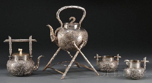 Four-piece Assembled Chinese Export Silver Tea Set: Four-piece Assembled Chinese Export Silver Tea Set, Hong Kong, late 19th/early 20th century, Wang Hing & Co., makers, an ovoid kettle with upright bamboo-form handle, with applied decoration of birds 