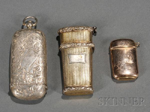 Three Match Safes, two English examples, both Bir: Three Match Safes, two English examples, both Birmingham, including a gold-washed engine-turned, 1828, maker's mark IT, with three foliate horizontal bands, lg. 2 7/8, and a 1901 ovoid engraved with l
