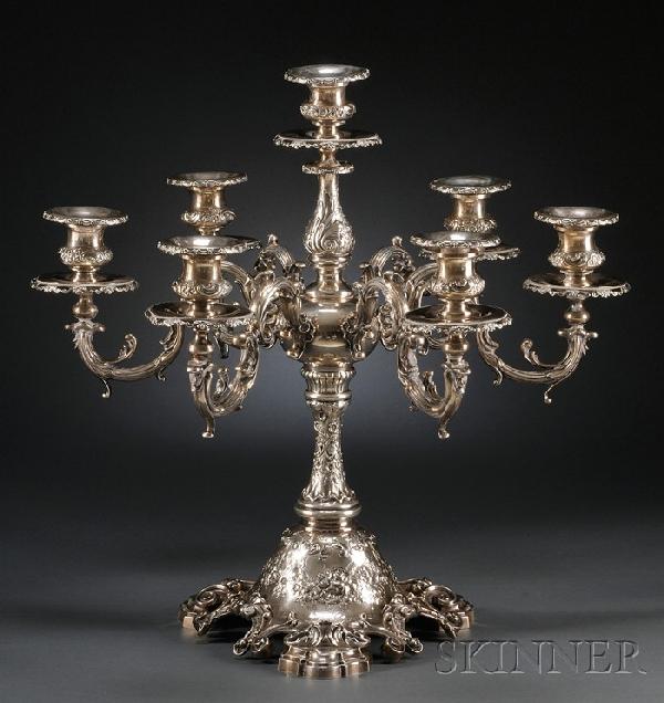 Large Mauser Sterling Seven-light Candelabrum, ea: Large Mauser Sterling Seven-light Candelabrum, early 20th century, with foliate chased and embossed thistle sconces and drip pans with C-scroll rims, center sconce on baluster stem over orb supporting