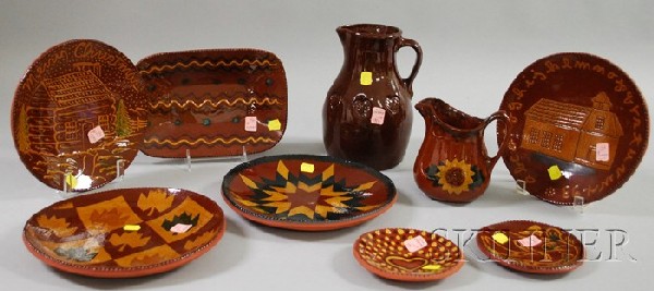 Nine Pieces of Foltz Pottery Glazed and Slip-decor: Nine Pieces of Foltz Pottery Glazed and Slip-decorated Redware, Reinhold, Pennsylvania, four plates, a tray, two small dishes, and two jugs.