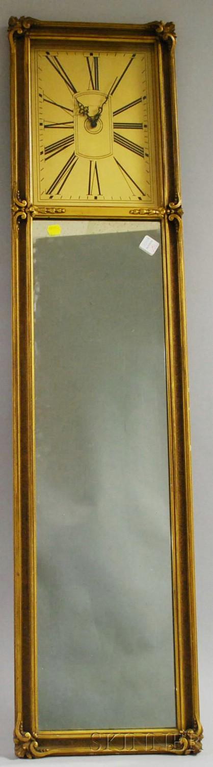 Gilt Mirror Clock by Tiffany & Company, gold-toned: Gilt Mirror Clock by Tiffany & Company, gold-toned dial with Roman numerals, pierced hands, gilded frame, and looking glass, ht. 46 1/2 in.