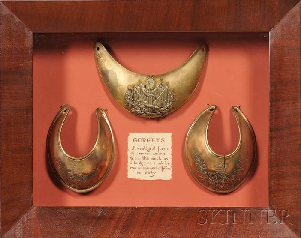 Three Brass English Gorgets, of various pattern an: Three Brass English Gorgets, of various pattern and size, framed in a mahogany frame shadow box, lg. 14, ht. 11 1/2 in.