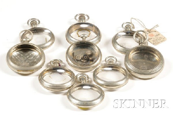 Nine Watch Movement Display Cases, all in silveroi: Nine Watch Movement Display Cases, all in silveroid or silverene, three marked Hamilton and two with original paper tags for Model 992 and 950, one marked Illinois, and five unmarked.