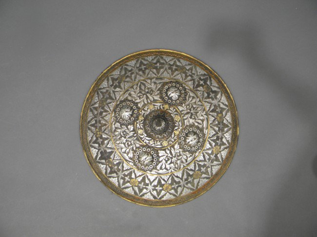 Persian Shield, early 20th century, copper inlaid : Persian Shield, early 20th century, copper inlaid with silver and gilt design of concentric circles of intertwined leafy scrolls, dia. approx. 13 1/2 in.