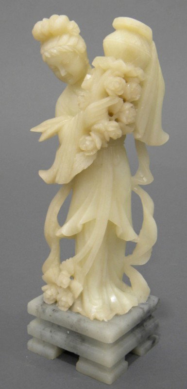 Soapstone Carving, China, carved as a female deity: Soapstone Carving, China, carved as a female deity standing atop a pedestal stand while carrying a flower basket, ht. 9 1/2 in.