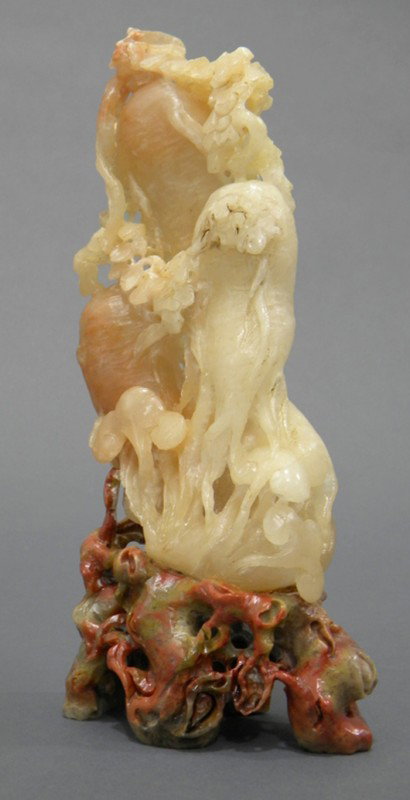 Soapstone Carving, China, carved from buff colored: Soapstone Carving, China, carved from buff colored soapstone as ginseng and lingzhi branches, contrasting with the green and red stone stand, ht. 10 1/2 in.