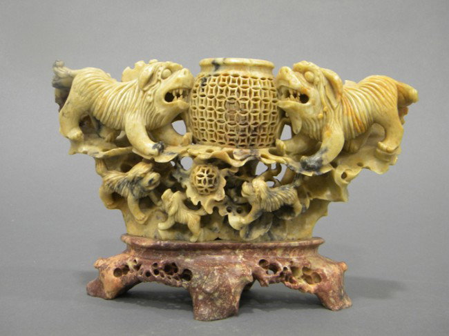 Soapstone Censer, China, the rounded censer with r: Soapstone Censer, China, the rounded censer with reticulated design of cash coins, surrounded by high relief carving of foo dog group, the lid surmounted by a seated foo dog, the stone of ochre color