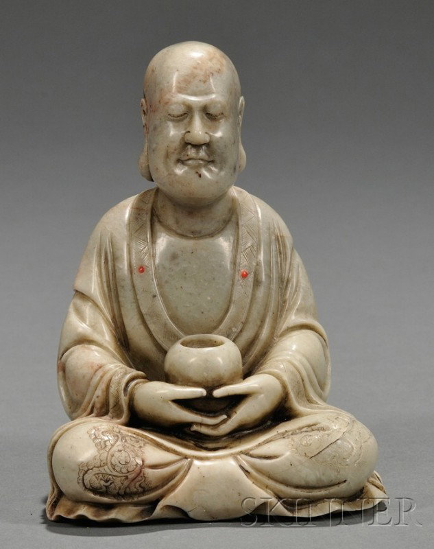 Soapstone Luohan, China, the seated figure of Luoh: Soapstone Luohan, China, the seated figure of Luohan holding a bo in both hands while meditating, finely incised floral scroll patterns to his robes, ht. 5 in.