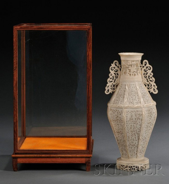 Ivory Vase, China, late 19th century, octagonal sh: Ivory Vase, China, late 19th century, octagonal shape, intricately carved with Buddhist figures engaging in various activities, the neck flanked by dragon scroll lugs, the foot carved and pierced with