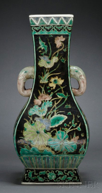 Famille Noir Vase, China, 19th century, supported: Famille Noir Vase, China, 19th century, supported on a pedestal foot, the hu-shaped body painted in enamels with lotus pond, the neck flanked by elephant head lugs, ht. 14 in.