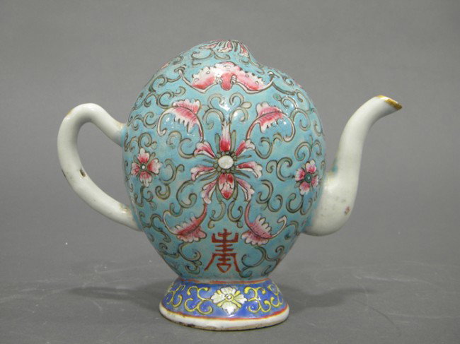 Cadogan Teapot, Chinese Export, in the shape of a : Cadogan Teapot, Chinese Export, in the shape of a peach, painted with shou characters, bats, and lotus scrolls, on a pale blue ground, ht. 6 in.