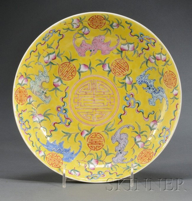 Polychrome Enameled Plate, China, Republican perio: Polychrome Enameled Plate, China, Republican period, the interior finely enameled with five bats amidst peach sprays, shou roundels, and beribboned items, reserved on an egg-yolk yellow glazed ground,