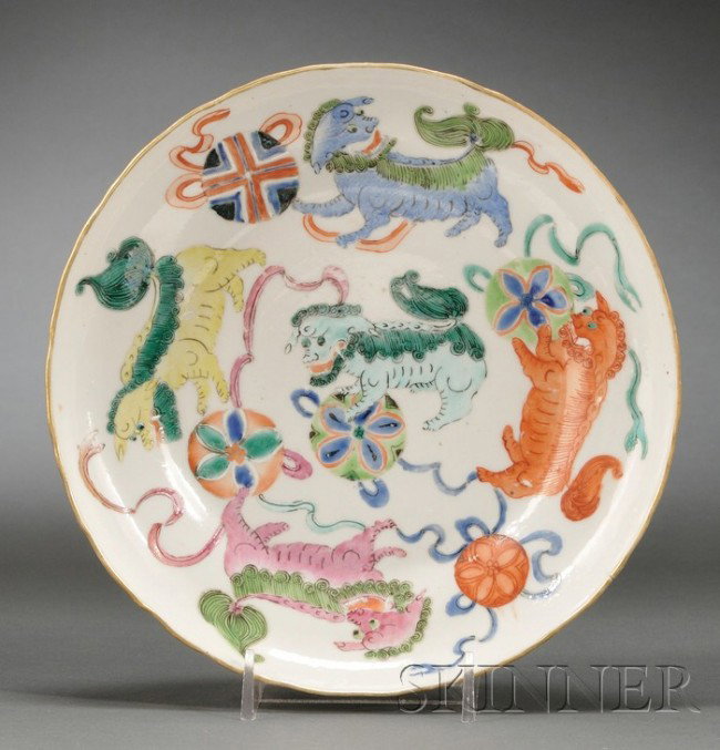 Polychrome Enameled Plate, China, 19th century, wi: Polychrome Enameled Plate, China, 19th century, with scalloped rim, the interior painted with five foo dogs in various colors each playing with a brocade ball, bats in iron red to the exterior, Daogua