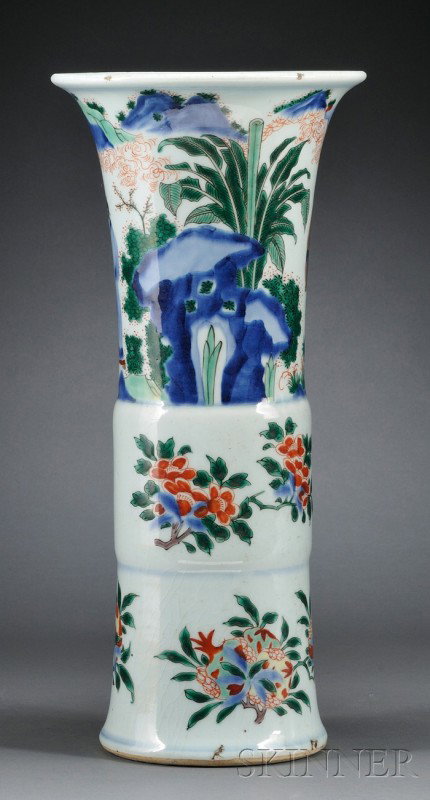 Wucai Beaker Vase, China, Transitional period, 17t: Wucai Beaker Vase, China, Transitional period, 17th century, the top section depicting dignitaries exchanging gifts in a garden setting, above a band of camellia and rose sprays in the middle, and pea