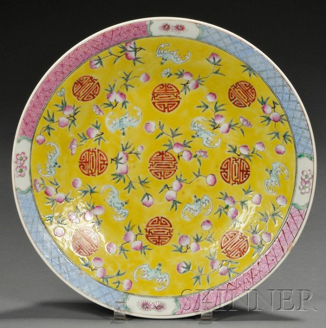 Yellow Enameled Charger, China, 19th century, the : Yellow Enameled Charger, China, 19th century, the interior decorated in famille rose palette with bats flying amidst peach sprays and shou roundels, reserved on an egg-yolk yellow ground, the exterior