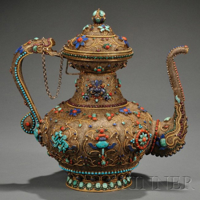 Large Silver Filigree Ewer, Tibet, the bulbous bod: Large Silver Filigree Ewer, Tibet, the bulbous body with cartouches enclosing the Eight Buddhist Treasures, all inset with turquoise, glass, coral, lapis lazuli, and garnet beads, elephant task spout,