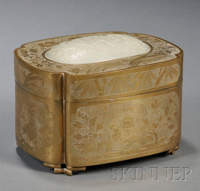 Brass Box and Cover with Jade Plaque, China, of qu: Brass Box and Cover with Jade Plaque, China, of quatrefoil shape, the cover inset with a 18th century pale celadon jade plaque carved in relief with three of the Eight Buddhist Treasures, surrounded w