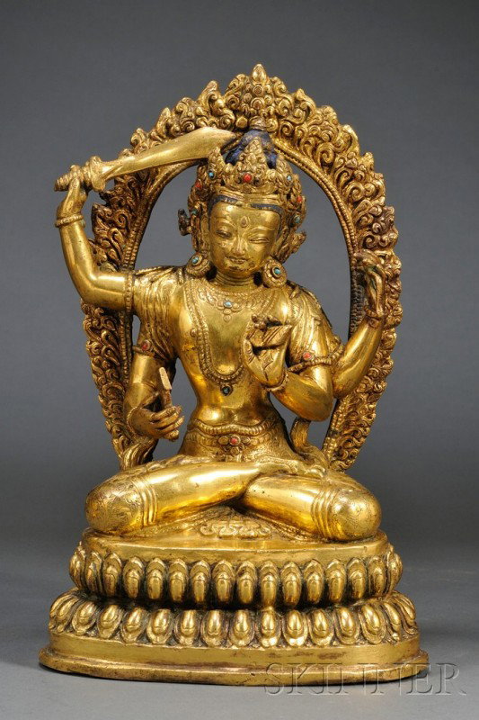 Gilt-bronze Manjusri, Tibet, 18th century, the fou: Gilt-bronze Manjusri, Tibet, 18th century, the four-armed divinity seated in dhyanasana pose atop a double-lotus throne, each hand holding a different tantric weapon including a sword, a noose, a book