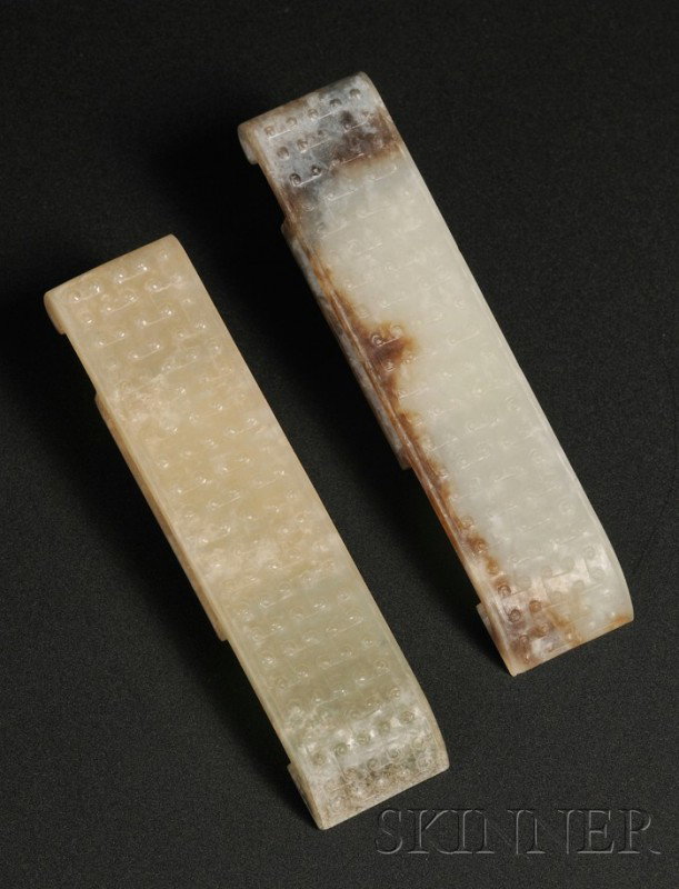 Pair of Jade Scabbard Slides, China, Warring Stat: Pair of Jade Scabbard Slides, China, Warring States style, of rectangular shape, the surface carved with angular scrolls, pale celadon color with russet markings, lg. 3 1/2 in.
