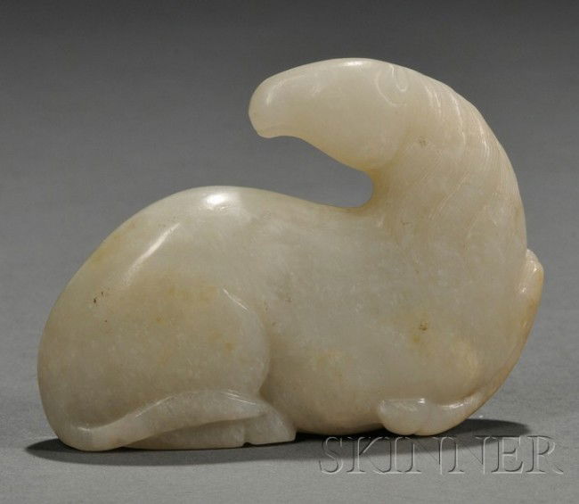 Jade Carving, China, carved as a recumbent horse: Jade Carving, China, carved as a recumbent horse with its legs tucked underneath, its head turned backwards, the stone of pale celadon color, lg. 3 1/2, ht. 2 3/4 in.