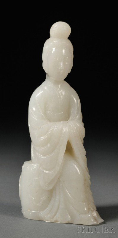 Jade Carving, China, 19th century, carved as a fe: Jade Carving, China, 19th century, carved as a female figure seated on a garden stool, the jade of white color with opaque mottling, lg. 5 7/8 in.