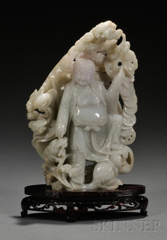 Jade Carving, China, carved as Liu Han with one f: Jade Carving, China, carved as Liu Han with one foot stepping on a double gourd, his right hand touching a toad which is biting on a cash coin, his left hand holding a strand of cash coins, with bats 