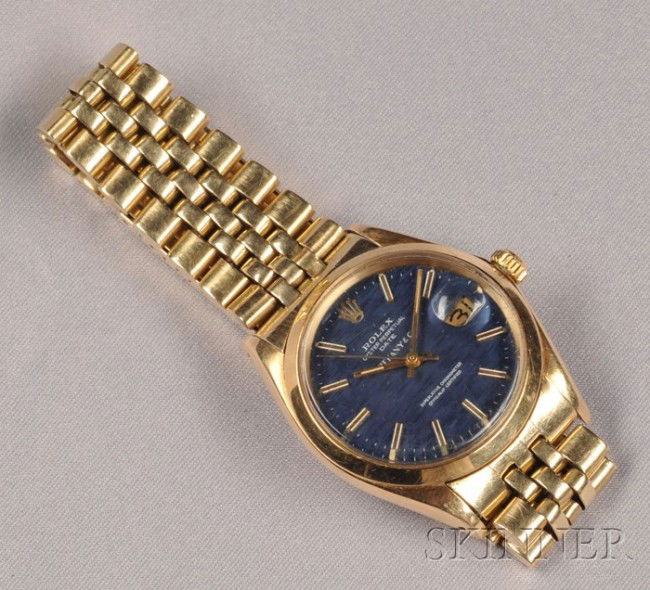 14kt Gold Wristwatch, Rolex, Tiffany & Co., "Oyste: 14kt Gold Wristwatch, Rolex, Tiffany & Co., "Oyster Perpetual Date," the blue dial with baton numeral indicators and date aperture, enclosing an automatic movement, completed by Jubilee bracelet with