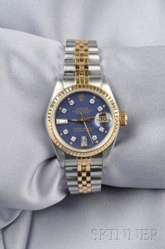 Ladies Stainless Steel and 18kt Gold Wristwatch, R: Ladies Stainless Steel and 18kt Gold Wristwatch, Rolex, "Oyster Perpetual Datejust," the blue metal dial with diamond numeral indicators and date aperture, enclosing automatic movement, completed by a