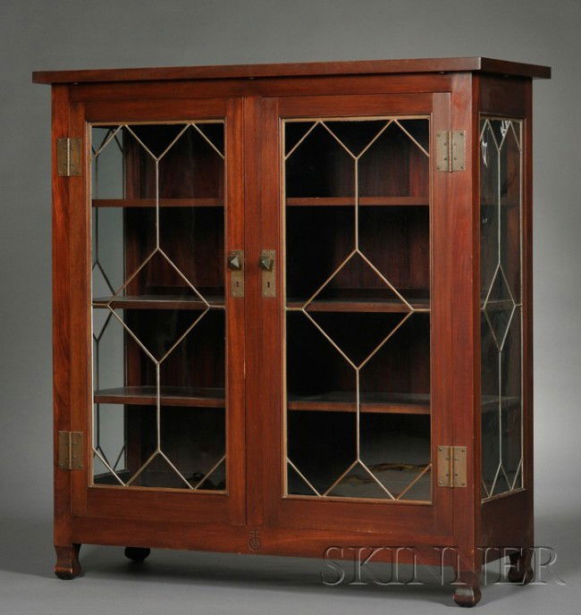 Roycroft Arts & Crafts Bookcase/China Closet Mahoga: Roycroft Arts & Crafts Bookcase/China Closet Mahogany, glass, and metal New York Overhanging rectangular top over two cabinet doors and side panels in a mosaic of diamond and lozenge-shaped glass with