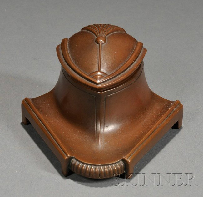 Art Nouveau Inkwell Cast bronze Early 20th century: Art Nouveau Inkwell Cast bronze Early 20th century Triangular form with hinged lid with stylized blossom in relief, milk glass insert, the back with molded mark JB 395, ht. 2, wd. 4 1/2, dp. 4 1/2 in.