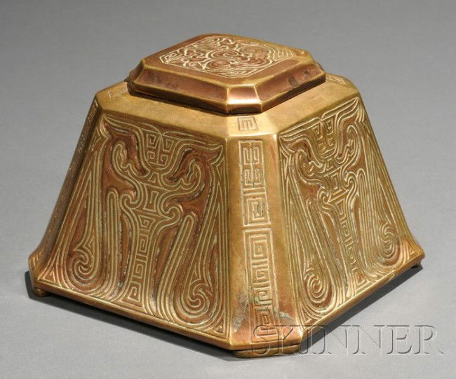Large Tiffany Studios Chinese Pattern Inkwell Bron: Large Tiffany Studios Chinese Pattern Inkwell Bronze New York, early 20th century Four decorated sides with cut corners, hinged lid, glass liner, marked Tiffany Studios New York 1753, ht. 4 1/8 in.