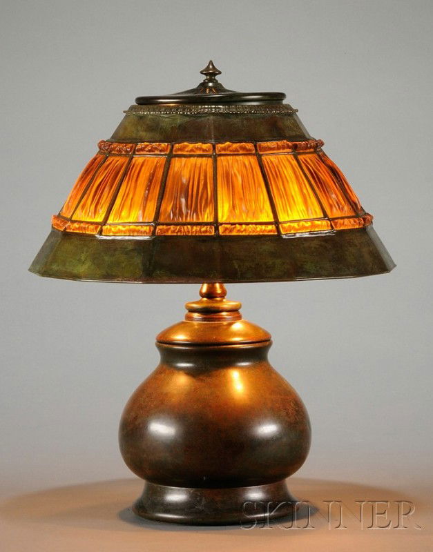 Tiffany Studios Linenfold Table Lamp Bronze and ar: Tiffany Studios Linenfold Table Lamp Bronze and art glass New York, early 20th century Sixteen-sided bronze verdigris shade fitted with amber colored linenfold glass, marked Tiffany Studios New York a