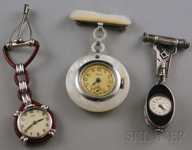 Three Pendant Watches, including a C. Bucherer ste: Three Pendant Watches, including a C. Bucherer sterling silver, onyx, marcasite, and gemstone watch (missing stones), and a Camille mother-of-pearl watch, 15-jewel movement.