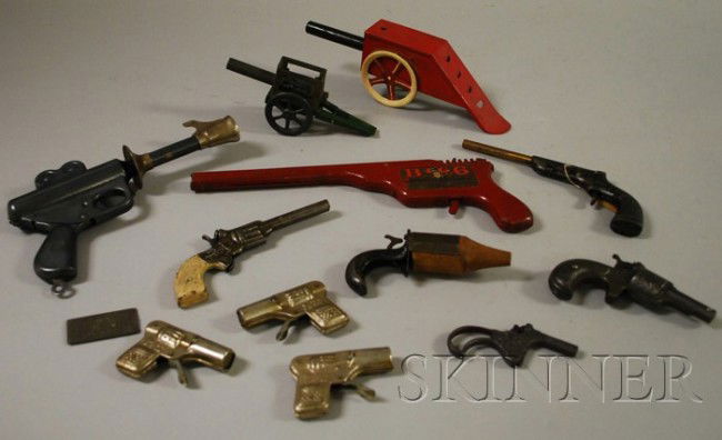Group of Tin and Metal Toy Guns and Artillery, in: Group of Tin and Metal Toy Guns and Artillery, including a "Buck Rogers 25th century gun", Daisy Manufacturing Company, a Kingston "Big 6" gun, two WW1-style artillery, etc.