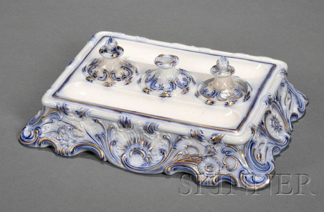 Wedgwood Flow Blue Decorated Pearlware Ink Stand,: Wedgwood Flow Blue Decorated Pearlware Ink Stand, England, c. 1845, shape 977, rectangular form with gilt trim to a molded rococo style floral and foliate border, the tray with three covered wells cen