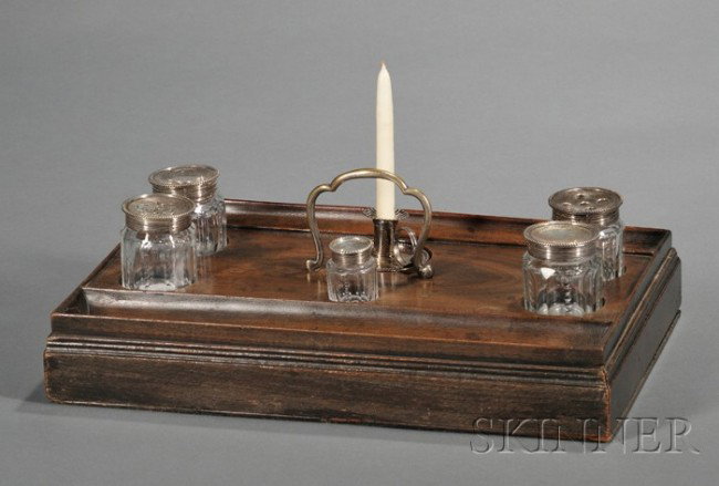 George III Seven-piece Desk Set, c. 1815. mahogany: George III Seven-piece Desk Set, c. 1815. mahogany stand with single drawer and two pen wells, with reserves for five paneled and cut colorless glass bottles with sterling silver lids, and a small tap