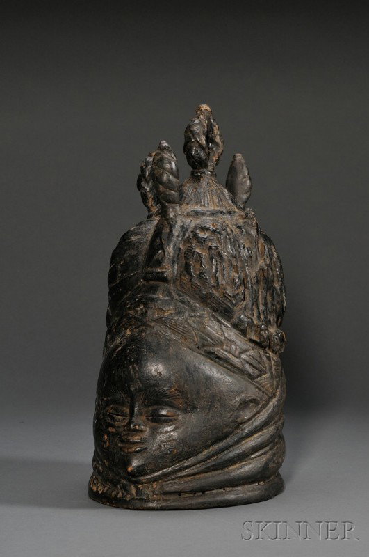 Mende Bundu Carved Wood Helmet Mask, with rolls of: Mende Bundu Carved Wood Helmet Mask, with rolls of fat at neck, pierced slit eyes and elaborate plaited and twisted coiffure, dark patina of use, ht. 17 in.