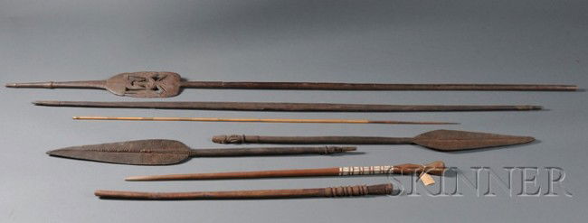 Seven Ethnographic Items, from New Guinea, two pad: Seven Ethnographic Items, from New Guinea, two paddles, a paddle-like spear, bow and one arrow, and club (?); from Solomon Island, a cane with shell inlays, lg. to 81 in.