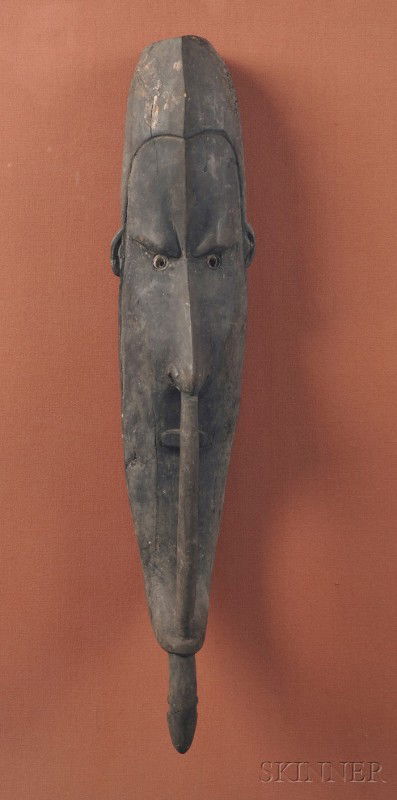 New Guinea Carved Wood Mask, Sepik River, an ances: New Guinea Carved Wood Mask, Sepik River, an ancestral guardian mask with shell inlaid eyes, mounted in a Lucite box, lg. 24 in. Provenance: Karl Mann, E. 59th St., New York.