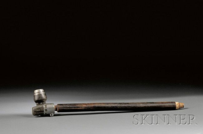 Northern Plains Pipe, Cree, c. 19th century, with: Northern Plains Pipe, Cree, c. 19th century, with tulip-shape black steatite, lead inlaid bowl, the round wood stem with single red painted groove, lg. 13 5/8 in.