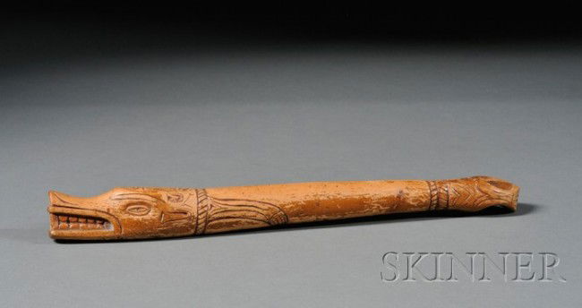 Northwest Coast Carved Wood Club, c. 1900, carved: Northwest Coast Carved Wood Club, c. 1900, carved with stylized animal head and feline designs, it appears to have been painted and varnished at one time, lg. 14 1/2 in.
