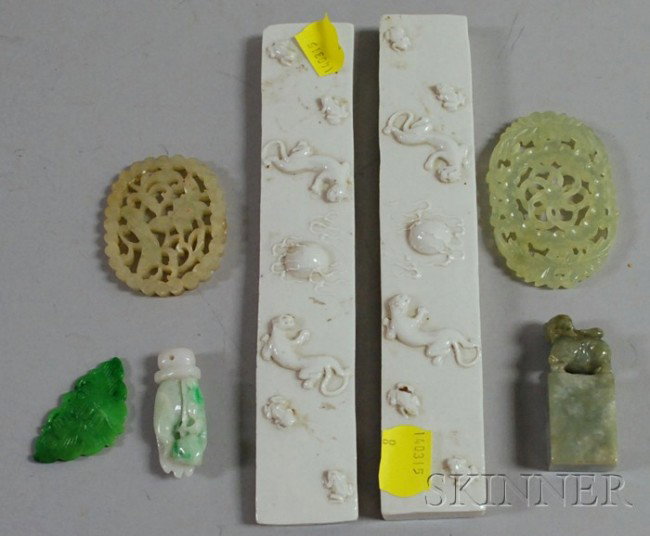 Pair of White Chinese Ceramic Scroll Rests and Fiv: Pair of White Chinese Ceramic Scroll Rests and Five Carved Jade Items, scroll rests decorated with lizards and frogs, signed on base, lg. 6 3/4, a carved foo dog stamp, a green moth pendant, a pendant