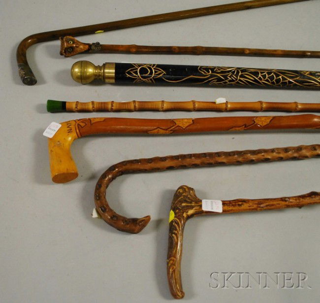 Seven Assorted Carved Walking Rootwood and Bamboo: Seven Assorted Carved Walking Rootwood and Bamboo Walking Sticks and Canes, including a pool cue.